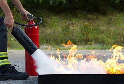 Fire Extinguisher Use on flames in an open training Setting 